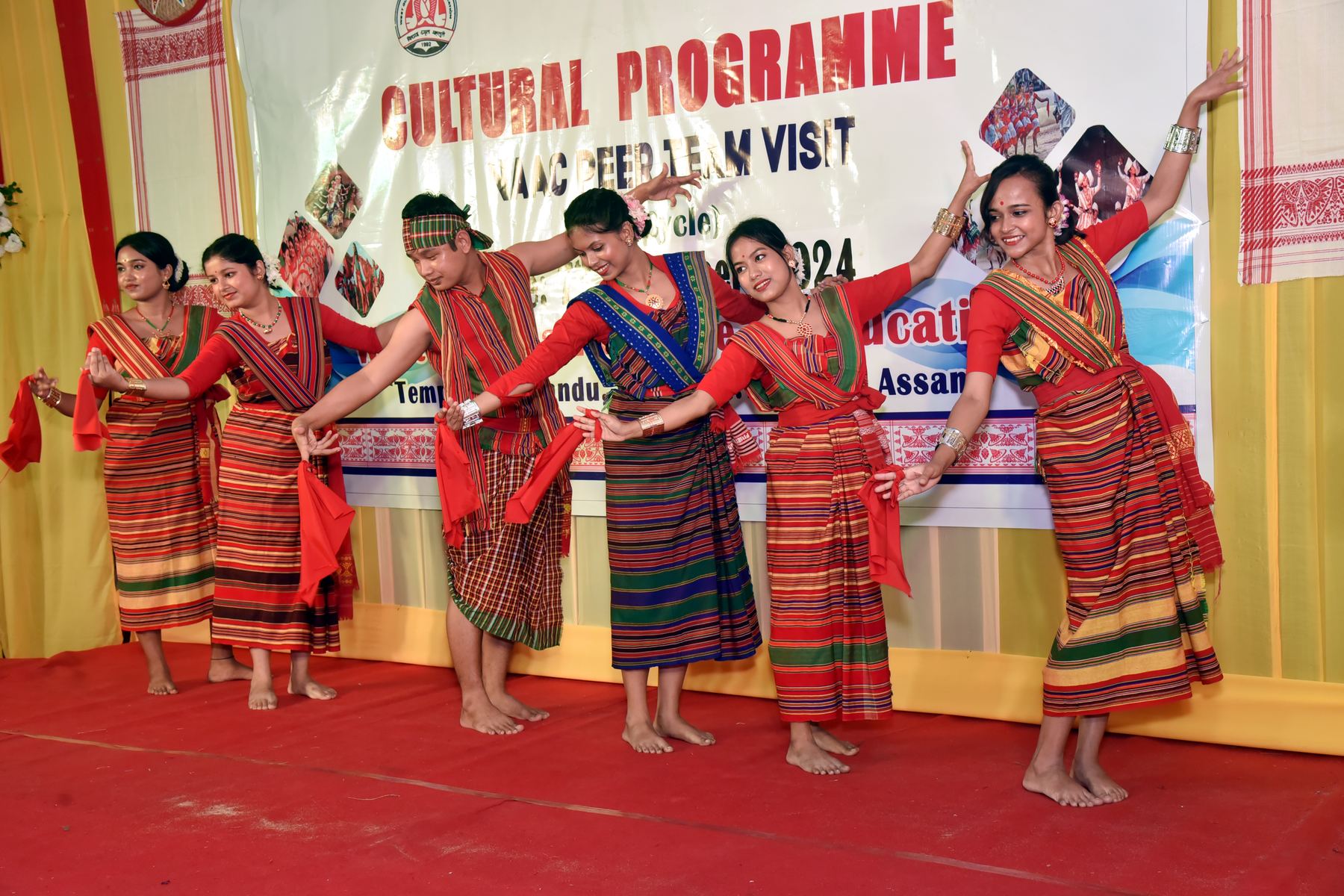 Student-teachers performing a Bihu dance on stage